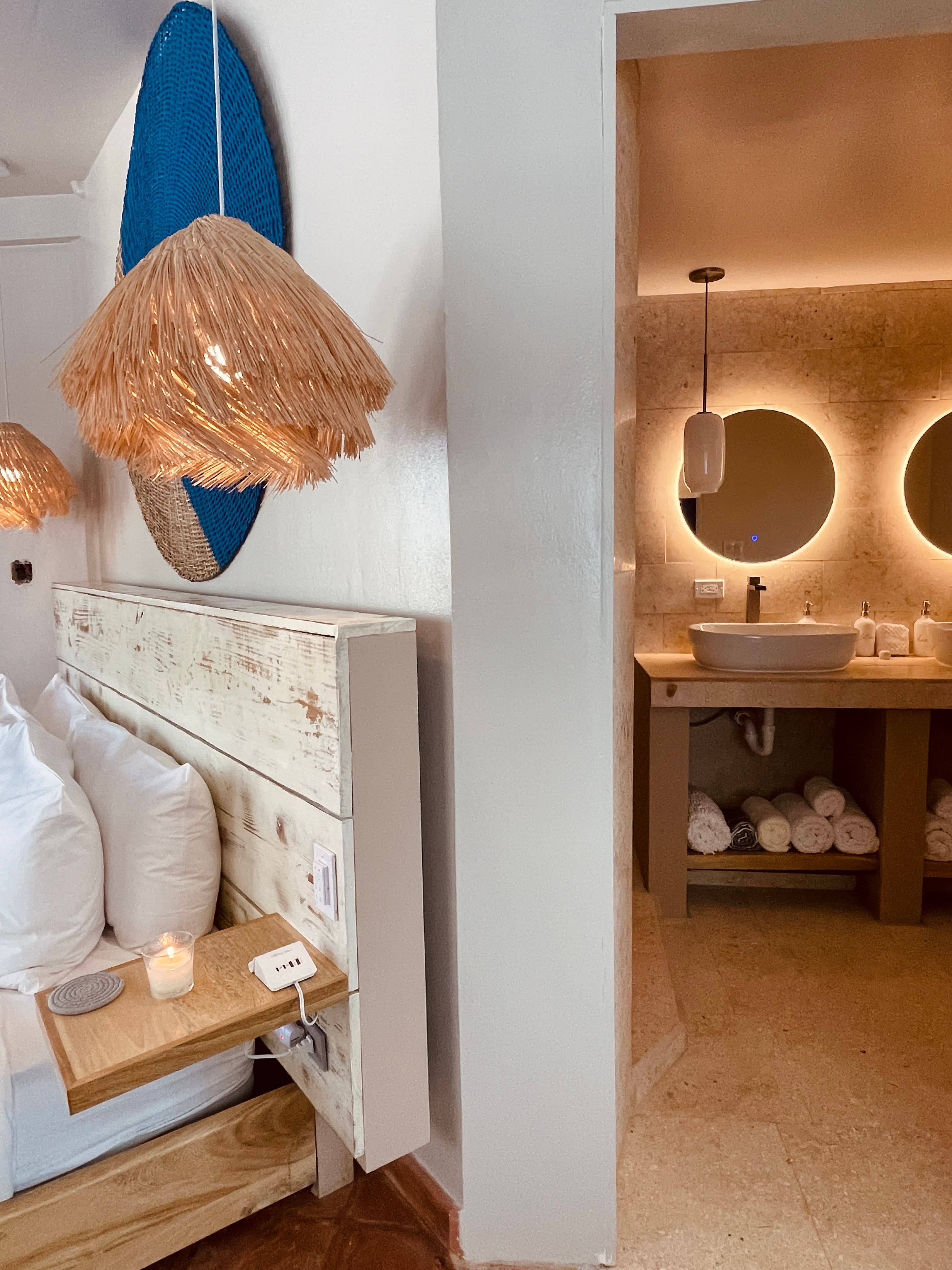Spa style bathroom just beyond the pocket door with soft lighting.