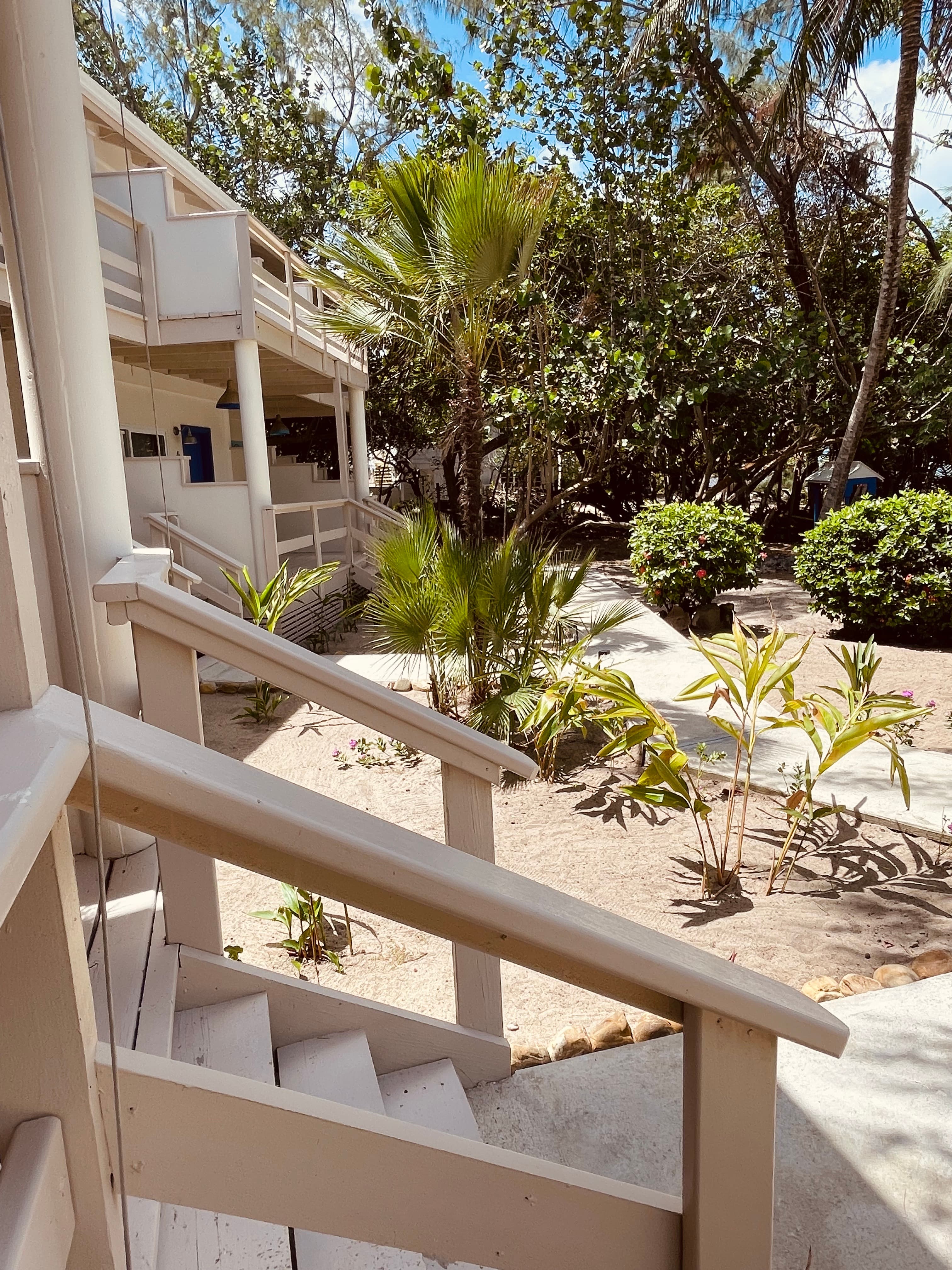 The poolside walkway with steps up to rooms 1-7