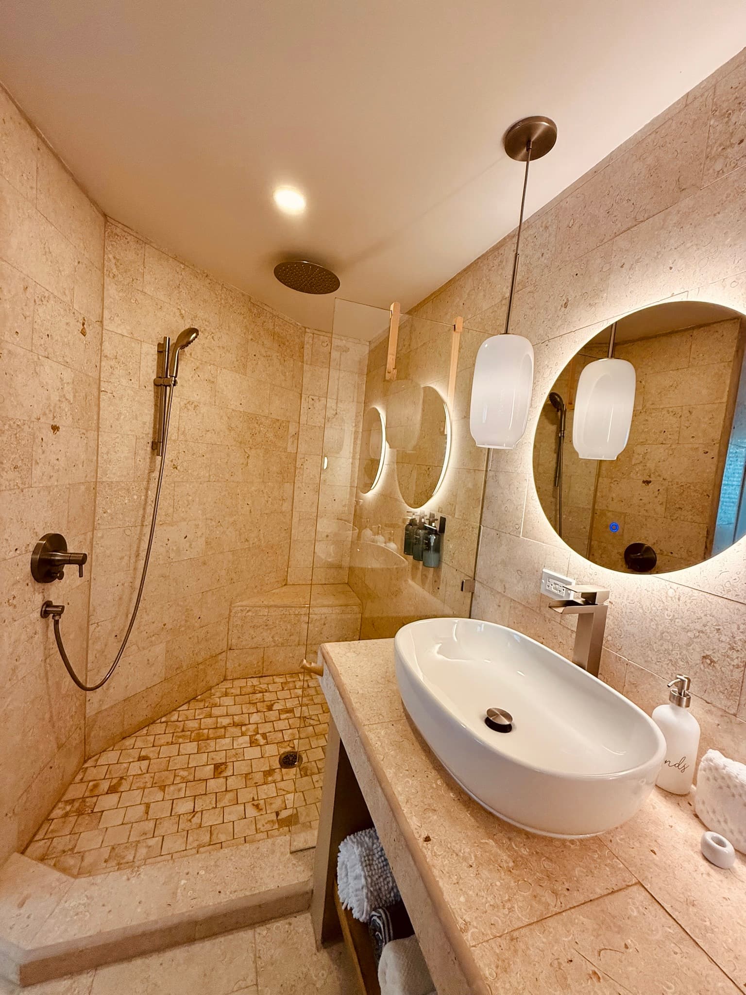 Rain shower with eco conscious toiletries and spa lighting.