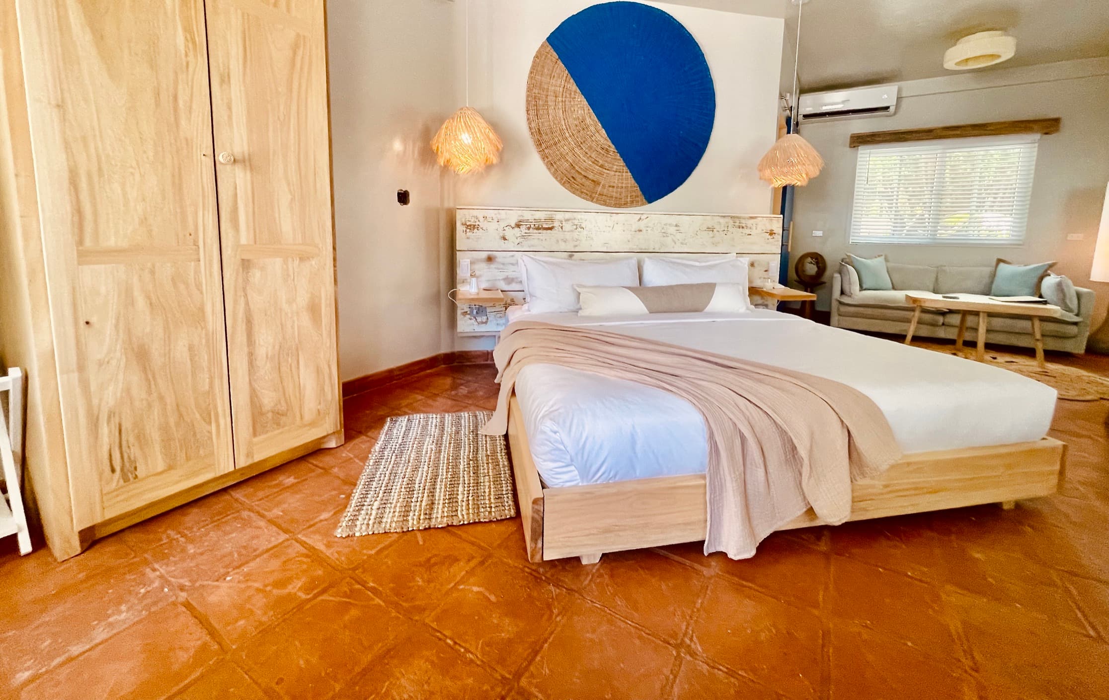King sized bed with closet and views of the pool and beach