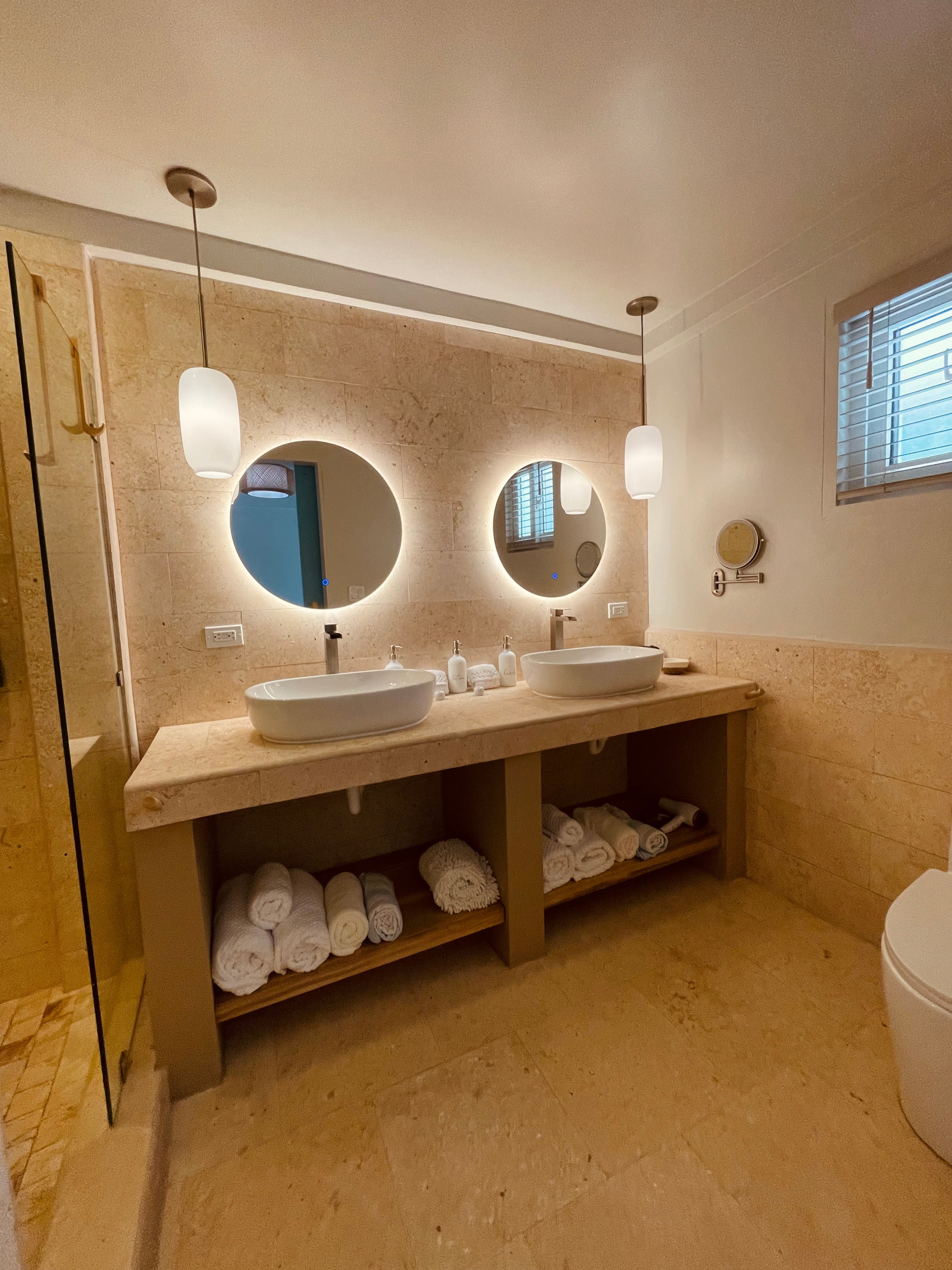 Cool, tiled bathroom with plush towels, beach towels and hairdryer