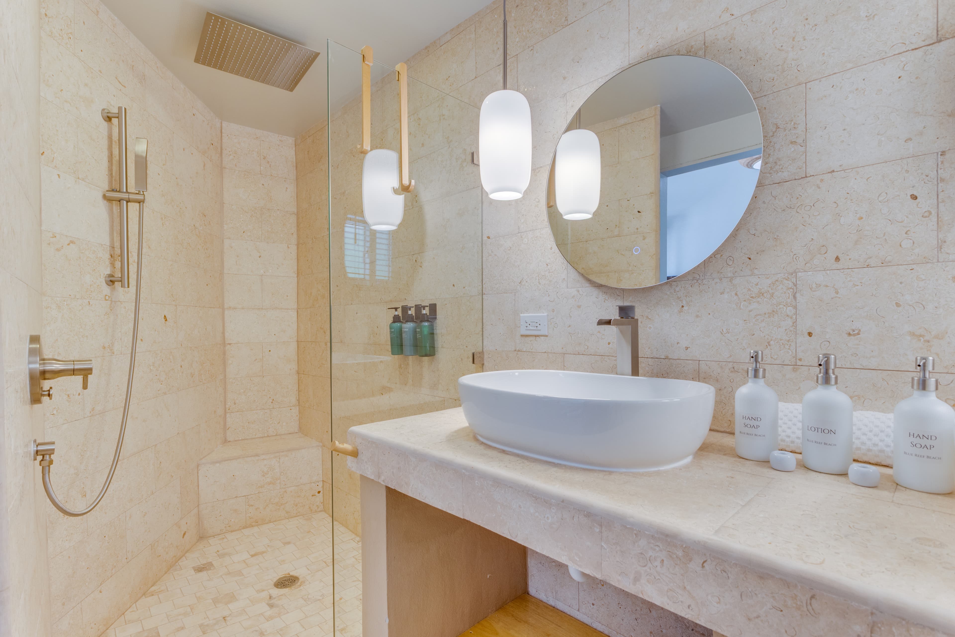 Spa-style bathroom: rain shower, eco body wash, lotion, shampoo and conditioner