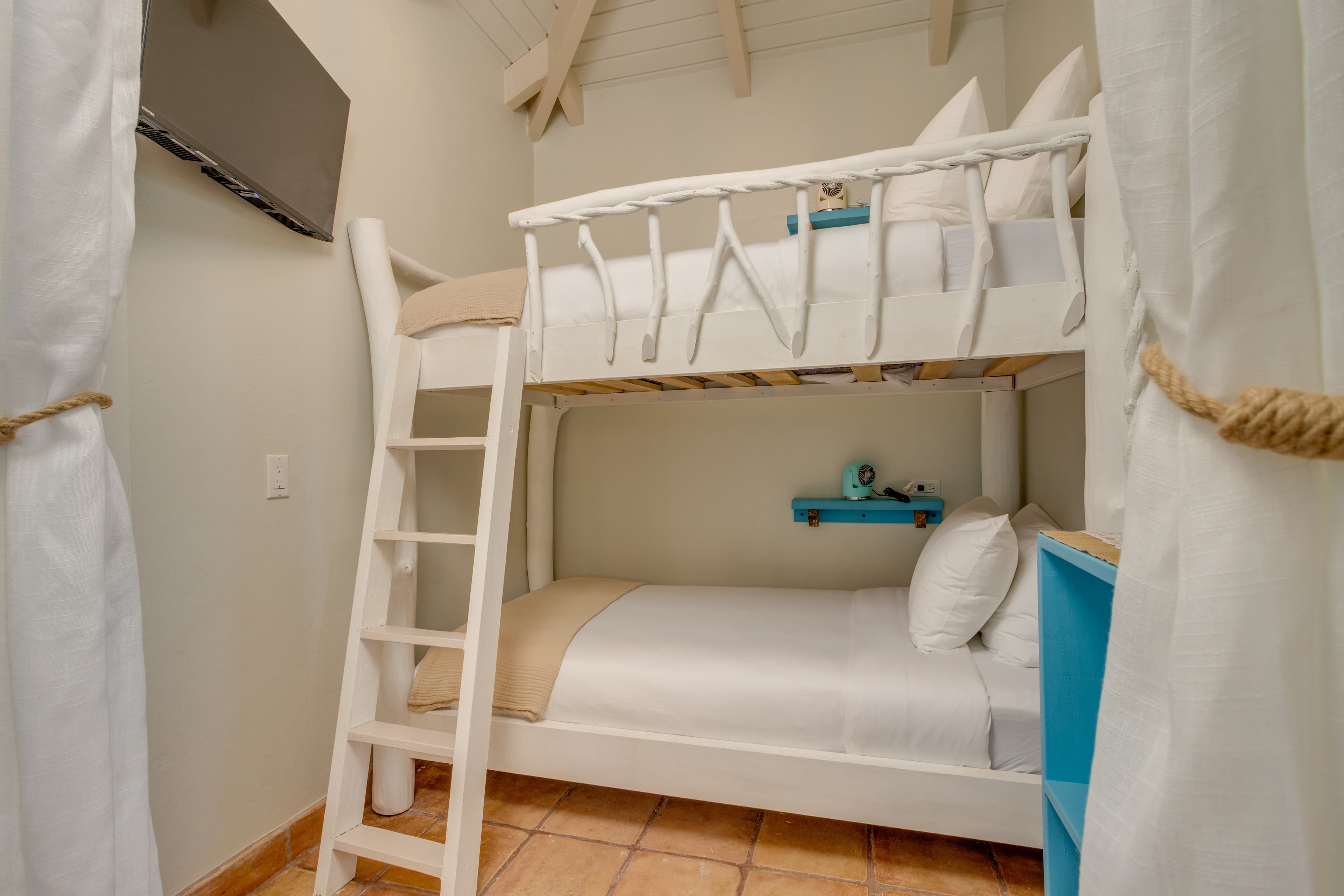 A cosy nook for the little ones to snooze in style, complete with TV and fans