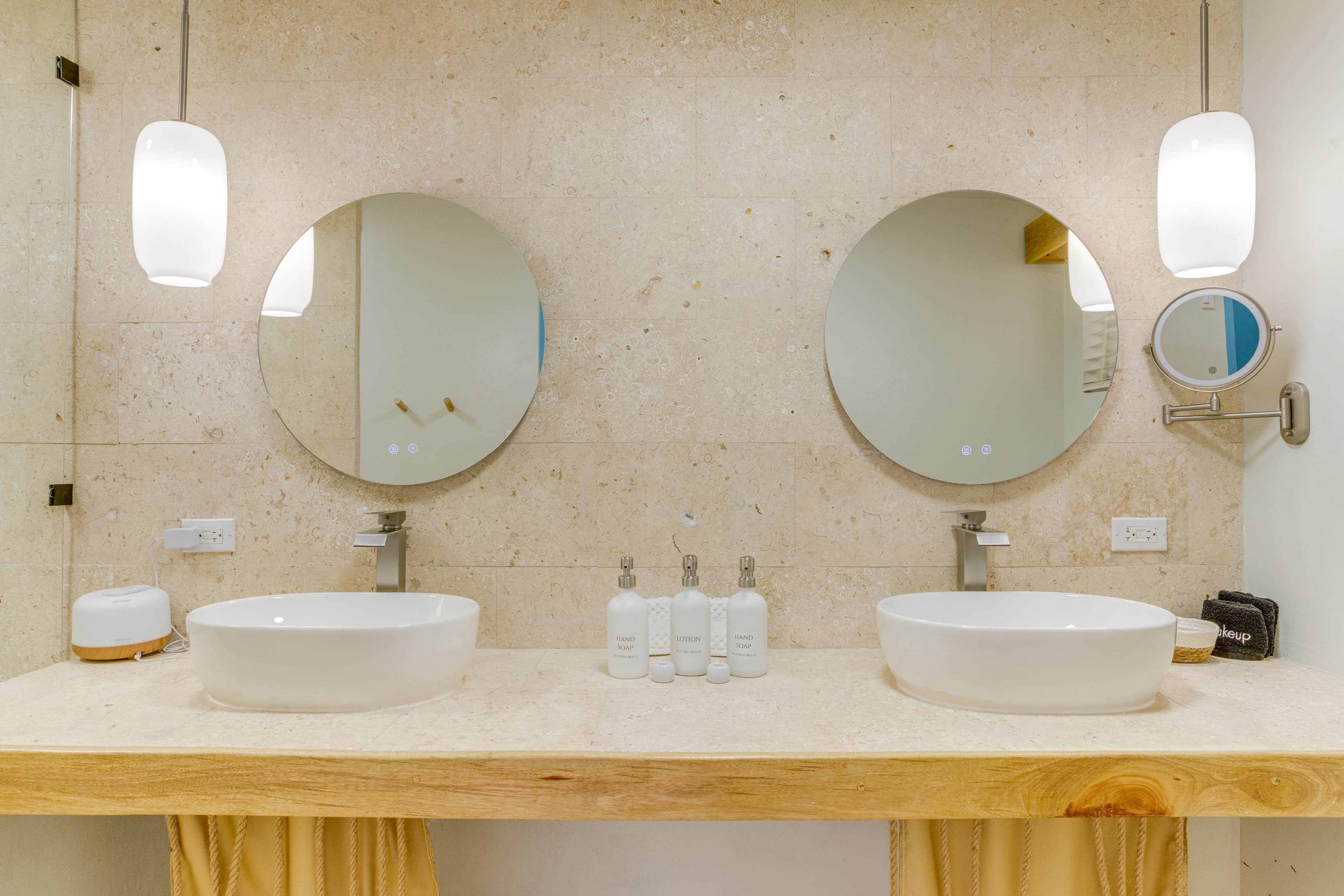 Spa-style bathroom: rain shower, eco body wash, lotion, shampoo and conditioner