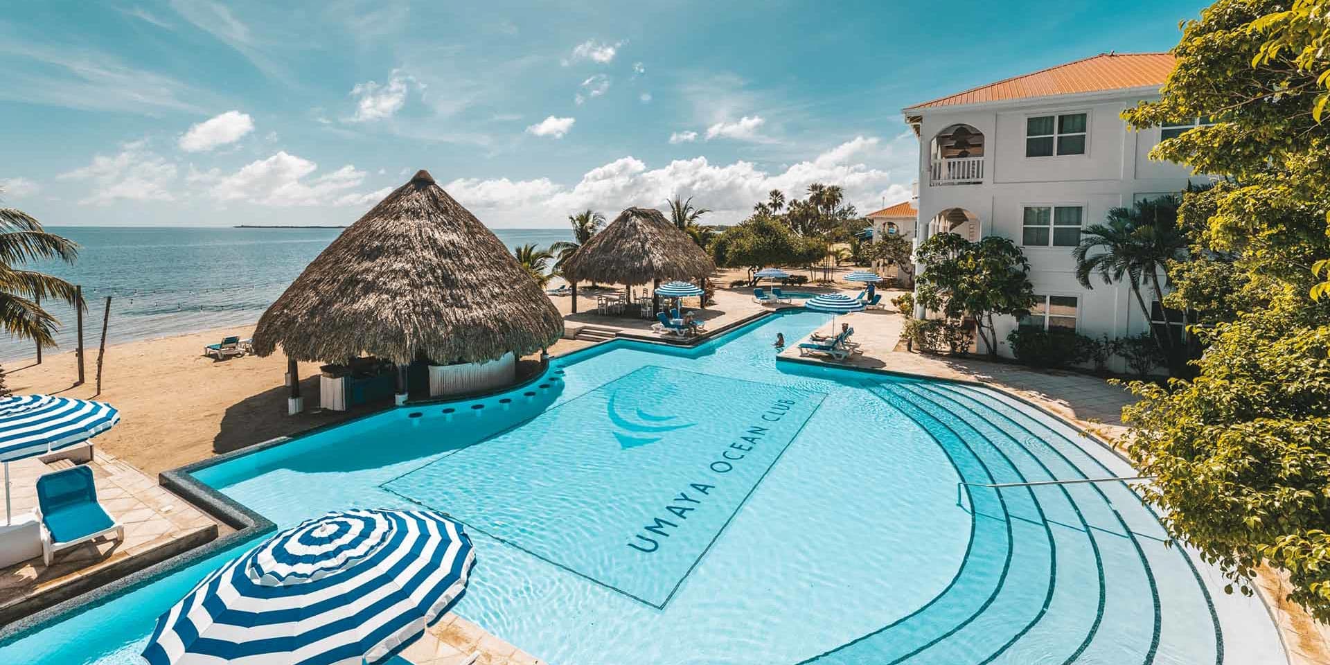 Breathtaking overhead view of the magnificent resort pool and luxury beachfront villa accommodations at Umaya Resort, a premier retreat on Maya Beach, Placencia Peninsula, Southern Belize
