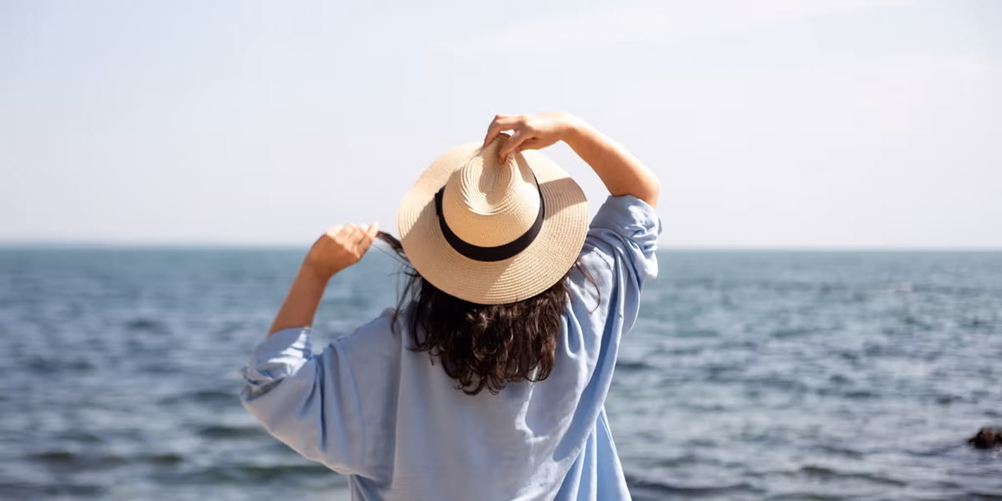 A woman standing on the beach at Blue Reef Beach Resort