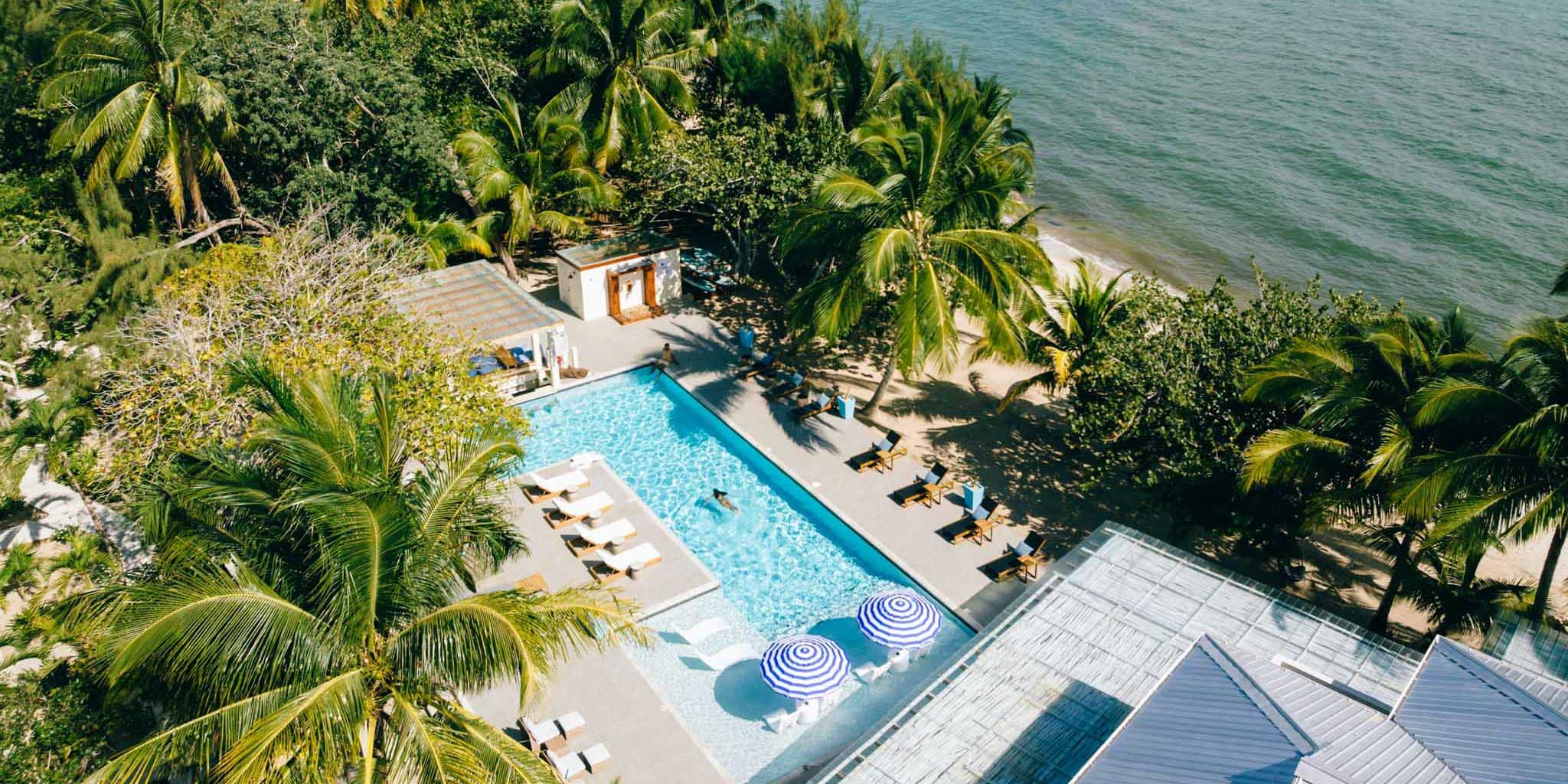 An aerial of a guest swimming in the pool at Blue Reef Beach & Marina in placencia