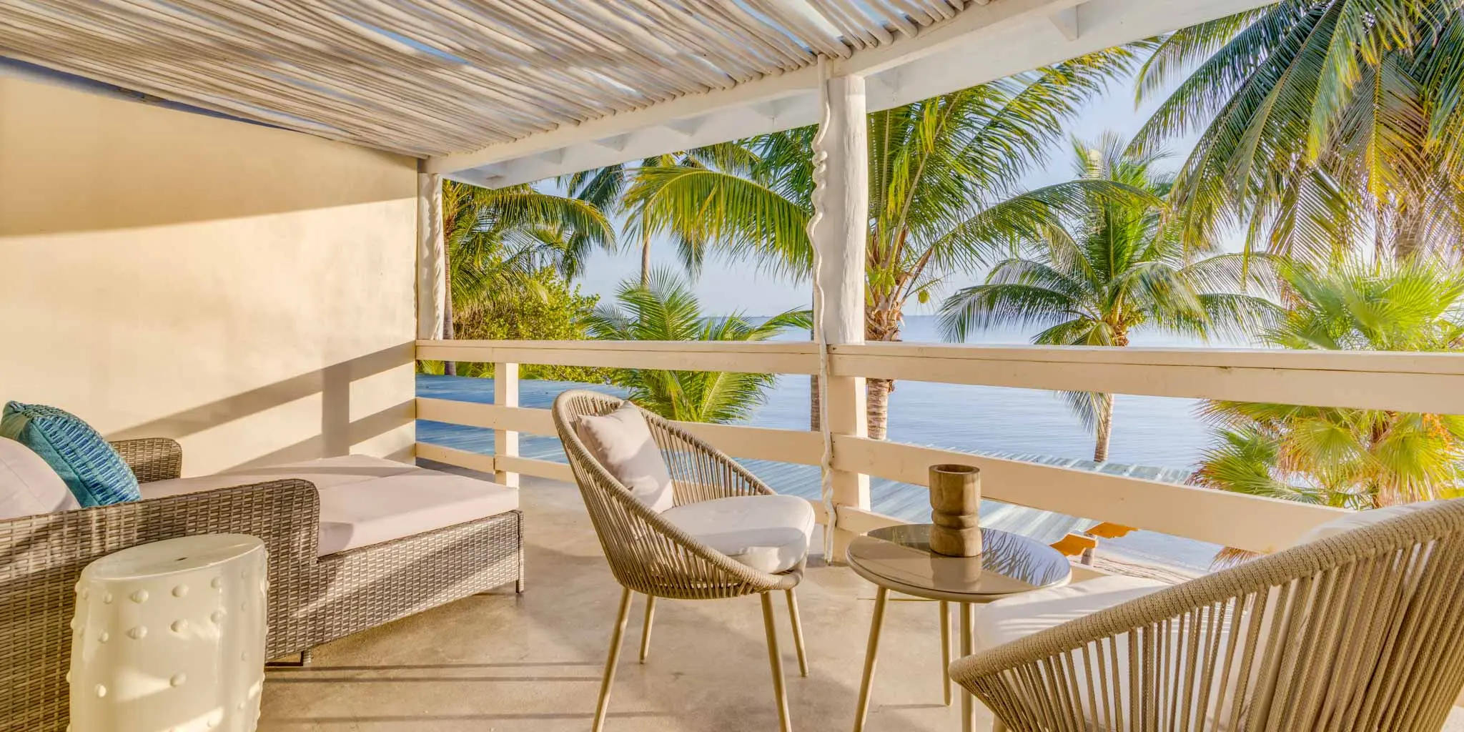 Balcony of a second-floor unit at Blue Reef Beach Resort, overlooking the beachfront with a view of coconut trees and the ocean.