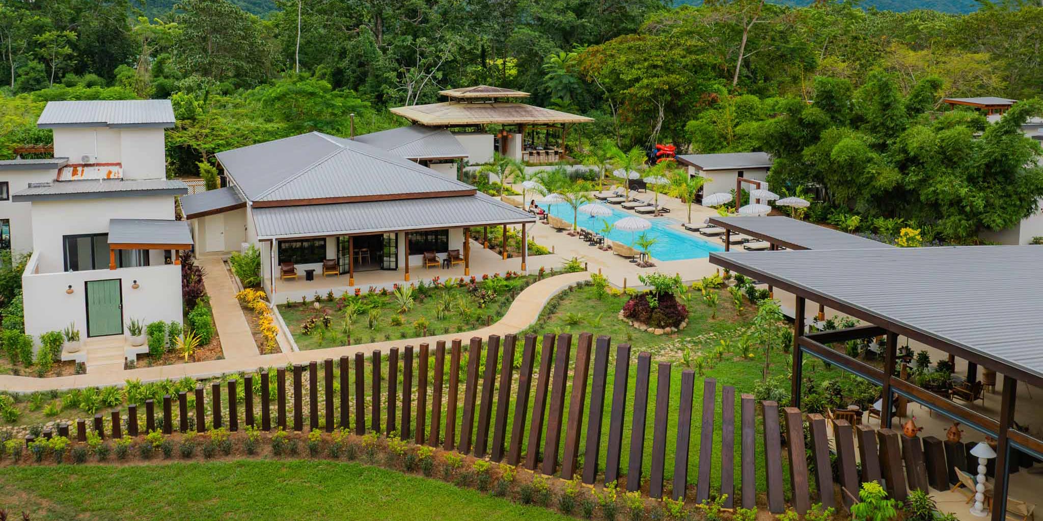 Breathtaking overhead view of The Banks Resort eco lodge immersed in the lush Sibun River Valley rainforest, Cayo District, Belize